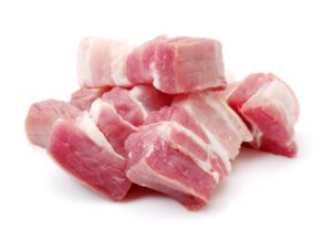 Raw pork belly pieces on a white background